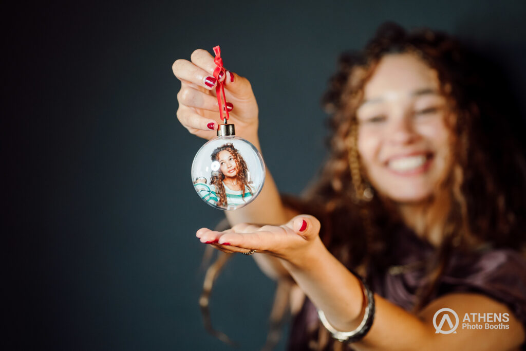 Woman holding Christmas photo ornament